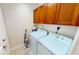 Laundry area with washer, dryer, and storage cabinets at 1340 Rock Dove Ct # 143, Punta Gorda, FL 33950