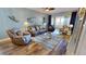 Comfortable living room featuring stylish decor, a ceiling fan, wood floors, and sliding glass doors to the outside at 1340 Rock Dove Ct # 143, Punta Gorda, FL 33950