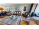 Inviting living room with comfortable seating, a glass coffee table, wood floors, and access to the balcony at 1340 Rock Dove Ct # 143, Punta Gorda, FL 33950