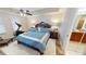 Well-appointed main bedroom featuring a luxurious bed, an exercise machine, and an en-suite bathroom at 1340 Rock Dove Ct # 143, Punta Gorda, FL 33950