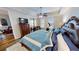 Bright main bedroom with balcony access, wood floors, ceiling fan and a stationary bicycle at 1340 Rock Dove Ct # 143, Punta Gorda, FL 33950