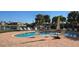 Community pool surrounded by lounge chairs and palm trees at 1340 Rock Dove Ct # 143, Punta Gorda, FL 33950