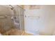 Tiled shower with glass door featuring river rock floor and decorative tile accent at 1340 Rock Dove Ct # 143, Punta Gorda, FL 33950