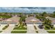 Overhead view of home in a lush community with mature palm trees and well-kept landscaping at 1706 Fountain View Cir, Venice, FL 34292