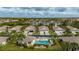 Inviting community featuring a pool, well-manicured lawns, and charming homes with attached garages and palm trees at 1706 Fountain View Cir, Venice, FL 34292