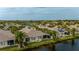 Waterfront home featuring screened-in patios in a tropical community with mature palm trees at 1706 Fountain View Cir, Venice, FL 34292