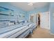 Charming bedroom featuring two beds, blue accents, an en-suite bathroom, and a walk-in closet at 1706 Fountain View Cir, Venice, FL 34292
