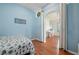 Bedroom featuring wood floors and coastal decor with an arched doorway at 1706 Fountain View Cir, Venice, FL 34292