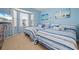 Bright bedroom with two beds, blue accents, carpet and serene decor, creating a tranquil retreat at 1706 Fountain View Cir, Venice, FL 34292