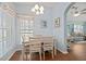 Cozy dining area featuring a table for four, bright window, and an open connection to the living room at 1706 Fountain View Cir, Venice, FL 34292