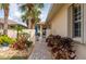 Pathway leading to the front entrance, surrounded by colorful plants and a gate at 1706 Fountain View Cir, Venice, FL 34292