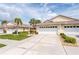 Charming home featuring a spacious driveway, attached garage, and lush green lawn at 1706 Fountain View Cir, Venice, FL 34292