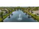Beautiful lake with fountains surrounded by lush landscaping and palm trees in a well-maintained community at 1706 Fountain View Cir, Venice, FL 34292