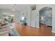 Spacious living room with hardwood floors, large windows, and seamless access to the screened lanai at 1706 Fountain View Cir, Venice, FL 34292