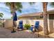 Charming patio area with comfortable lounge chairs, pavers, and privacy wall, perfect for outdoor relaxation at 1706 Fountain View Cir, Venice, FL 34292