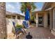 Outdoor patio featuring seating, a vibrant blue umbrella, and shaded areas at 1706 Fountain View Cir, Venice, FL 34292