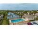Community pool with a view of the lake and fountain, surrounded by palm trees and well-maintained landscaping at 1706 Fountain View Cir, Venice, FL 34292