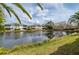 Water view of property from lush grassy bank of community lake at 1706 Fountain View Cir, Venice, FL 34292