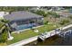 Aerial view of the backyard, pool, boat dock, and lush landscaping, ideal for relaxing and entertaining at 17350 Bayharbor Cir, Port Charlotte, FL 33948
