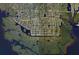 An aerial view displays the home's location within a grid of residences near winding canals and waterways at 17350 Bayharbor Cir, Port Charlotte, FL 33948