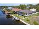 Stunning aerial showcases the home’s canal-front location, screened pool, private dock, and meticulous landscaping at 17350 Bayharbor Cir, Port Charlotte, FL 33948