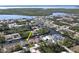Aerial view of a waterfront property on a canal with access to the bay, surrounded by lush greenery at 17350 Bayharbor Cir, Port Charlotte, FL 33948