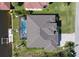 Overhead shot of the home displaying the roof, screened pool, backyard, and private dock on the canal at 17350 Bayharbor Cir, Port Charlotte, FL 33948