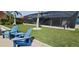 Inviting outdoor space featuring a screened-in pool, well-manicured lawn, and a private dock for waterfront enjoyment at 17350 Bayharbor Cir, Port Charlotte, FL 33948