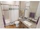 Stylish bathroom with a granite countertop vanity, tile flooring, and a shower with tub at 17350 Bayharbor Cir, Port Charlotte, FL 33948
