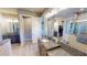 Bright bathroom featuring granite counters, dual sinks, glass enclosed shower, and tiled floors at 17350 Bayharbor Cir, Port Charlotte, FL 33948
