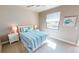 Cozy bedroom with coastal decor, ceiling fan, side tables, and bright light from the window at 17350 Bayharbor Cir, Port Charlotte, FL 33948