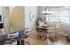 Bright dining area with wood flooring, round wood table, and lots of natural light from large windows at 17350 Bayharbor Cir, Port Charlotte, FL 33948