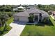 Well maintained, updated, single Gathering home features a spacious three car garage, manicured lawn, and elegant canal access at 17350 Bayharbor Cir, Port Charlotte, FL 33948