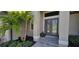 This home's front entrance features a lovely tiled step-up, fresh landscaping, and a charming double-door entry way at 17350 Bayharbor Cir, Port Charlotte, FL 33948