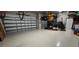 Spacious garage with epoxy flooring, kayak storage, and ample room for parking and storage at 17350 Bayharbor Cir, Port Charlotte, FL 33948
