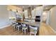 Modern kitchen with granite counters, stainless appliances, island with seating, and wood flooring at 17350 Bayharbor Cir, Port Charlotte, FL 33948