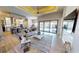 Living area view of open concept floor plan and easy pool access; kitchen and dining area in view at 17350 Bayharbor Cir, Port Charlotte, FL 33948