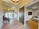 Open concept living space features modern tile floors, tray ceilings, a sliding barn door, and easy access to the pool at 17350 Bayharbor Cir, Port Charlotte, FL 33948
