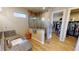 Stylish main bathroom with glass shower, stone floors, walk in closet, and wood look tile at 17350 Bayharbor Cir, Port Charlotte, FL 33948