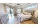 Spacious main bedroom with ceiling fan, ensuite bathroom, walk out to the pool, and tile flooring at 17350 Bayharbor Cir, Port Charlotte, FL 33948