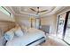Inviting main bedroom with ensuite bathroom, ceiling fan, walk out to lanai, and tile flooring at 17350 Bayharbor Cir, Port Charlotte, FL 33948