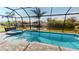 Gorgeous screened-in pool and spa overlooking the canal provide a serene waterfront retreat at 17350 Bayharbor Cir, Port Charlotte, FL 33948