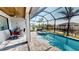 Inviting screened-in pool area with comfortable seating and beautiful canal views, perfect for outdoor living at 17350 Bayharbor Cir, Port Charlotte, FL 33948