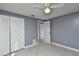 Bedroom with gray walls, tile flooring, a ceiling fan and closet at 18130 Steele Ave, Port Charlotte, FL 33948