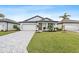 New construction home with paver driveway and landscaped lawn at 1890 Sunset Preserve Way, Port Charlotte, FL 33953