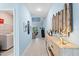 Hallway with laundry closet and access to other rooms at 1890 Sunset Preserve Way, Port Charlotte, FL 33953