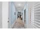 Light and airy hallway with blue walls and tile floor at 1890 Sunset Preserve Way, Port Charlotte, FL 33953