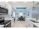 Modern kitchen with white cabinets and a view of the dining area at 1890 Sunset Preserve Way, Port Charlotte, FL 33953