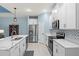 Modern kitchen with white cabinets, quartz countertops, and stainless steel appliances at 1890 Sunset Preserve Way, Port Charlotte, FL 33953