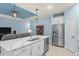 Modern kitchen with white cabinets, a large island, and stainless steel appliances at 1890 Sunset Preserve Way, Port Charlotte, FL 33953